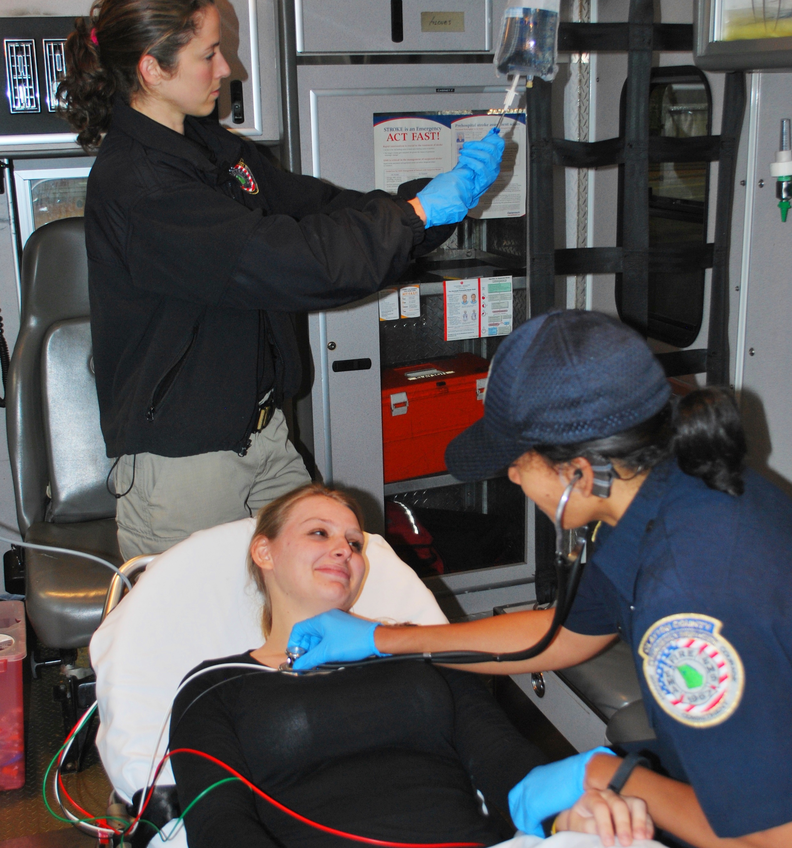 2 paramedics treating patient in ambulance