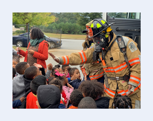 Firefighter high five with kids